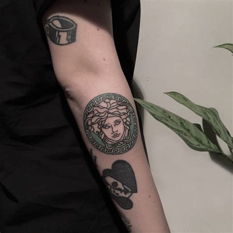 versace hair tattoo|Versace tattoo lettering.